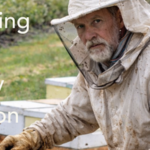 A beekeeper with bees and blueberries on Earth Day 2026